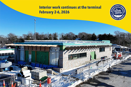 A terminal building under construction with snow on the ground, construction materials outside, and a project update banner at the top.